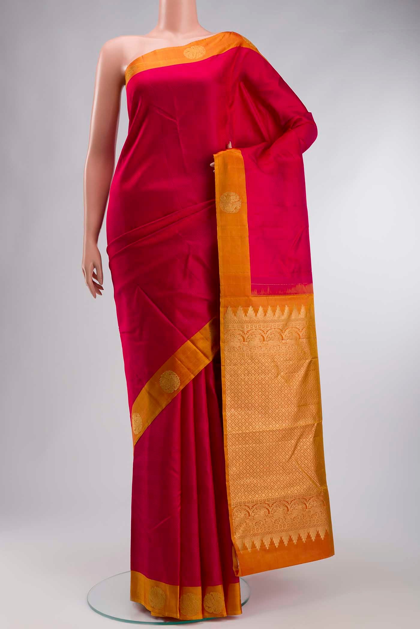 Pink Kanchipuram Silk Saree with Jacquard design on the body and Zari Border displayed on a mannequin