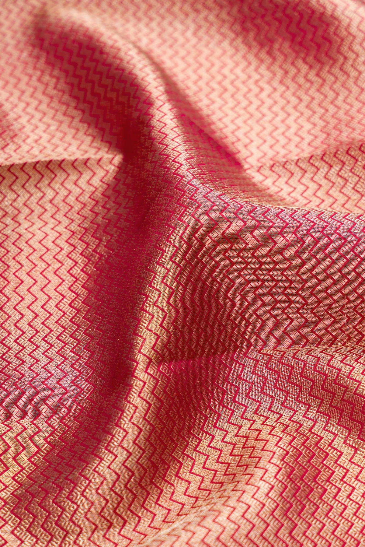 Close up of Maroon Kanjivaram Silk Saree with Zari Brocade on the body and Zari Border.  displaying folds