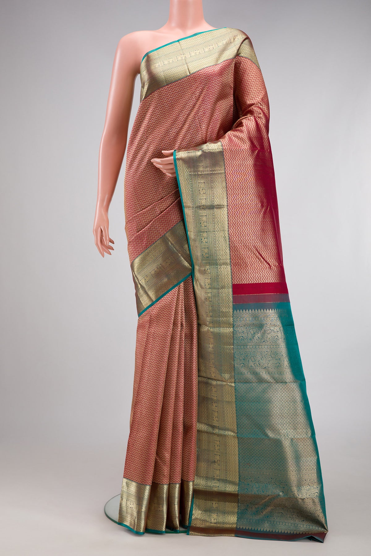Maroon Kanjivaram Silk Saree with Zari Brocade on the body and Zari Border.  displayed on a mannequin