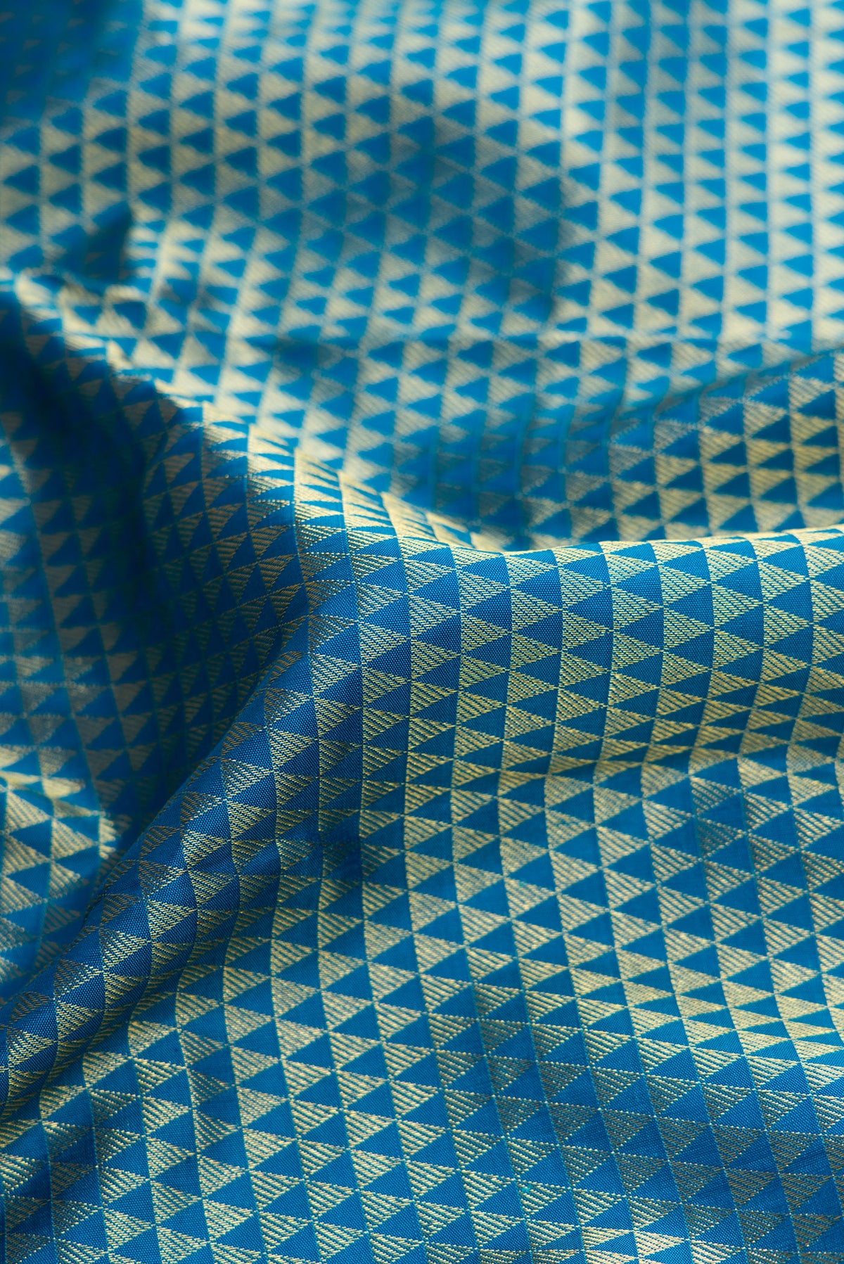 Close up of Peacock Blue Dual Tone Kanjivaram Silk Saree with Zari Brocade on the body and Zari Border.  displaying folds
