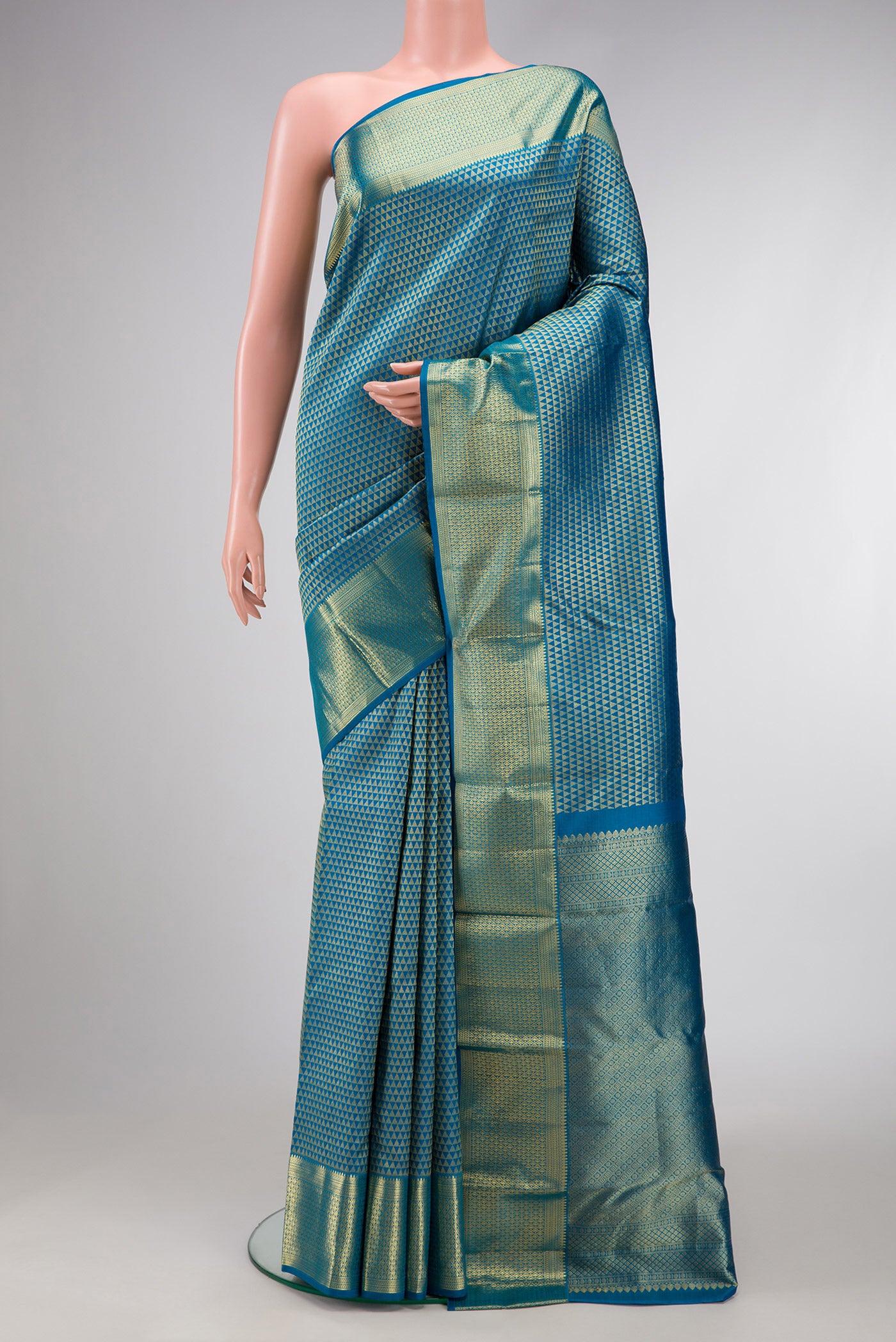 Peacock Blue Dual Tone Kanjivaram Silk Saree with Zari Brocade on the body and Zari Border.  displayed on a mannequin