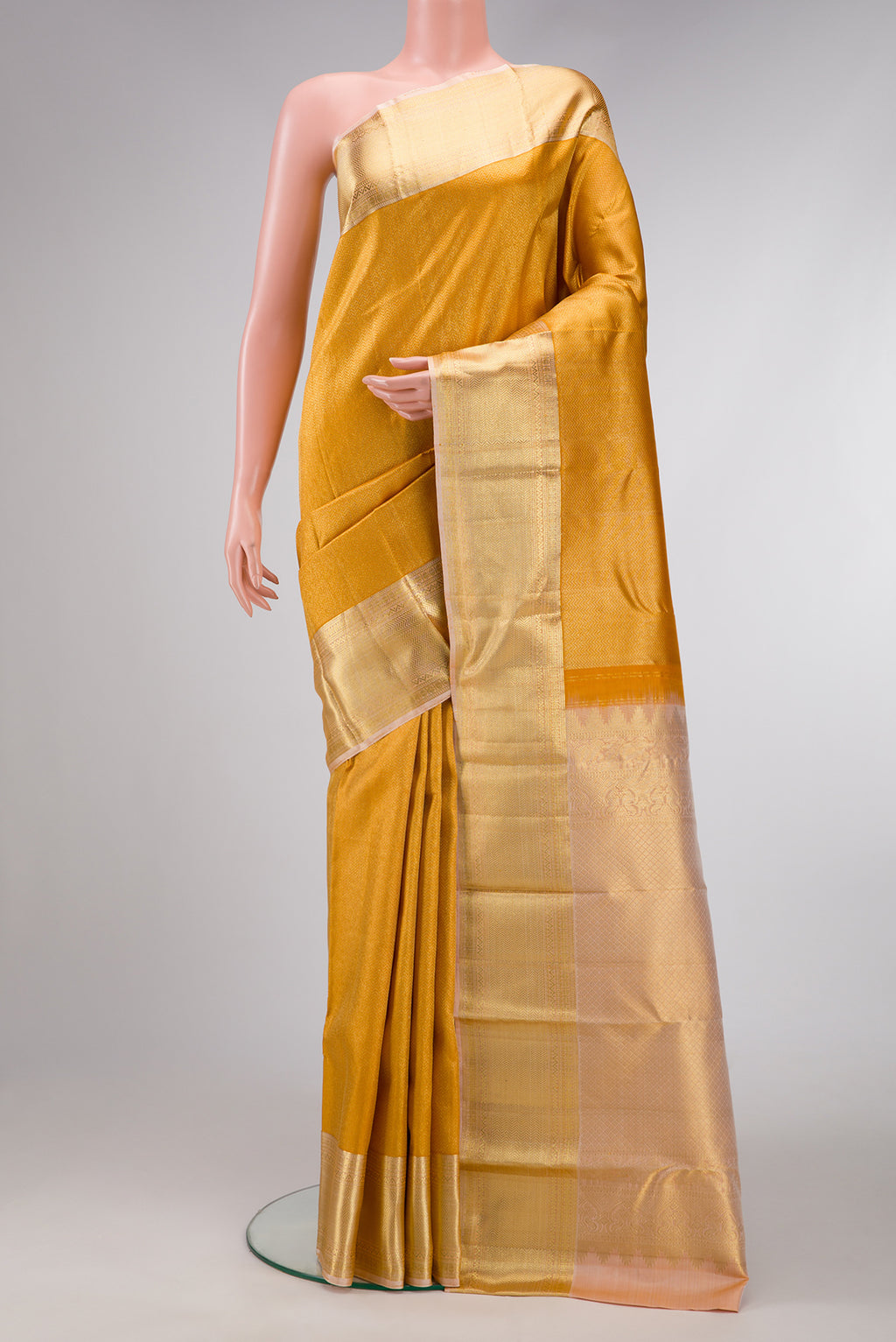 Gold Dual Tone Kanjivaram Silk Saree with Zari Brocade on the body and Zari Border.  displayed on a mannequin