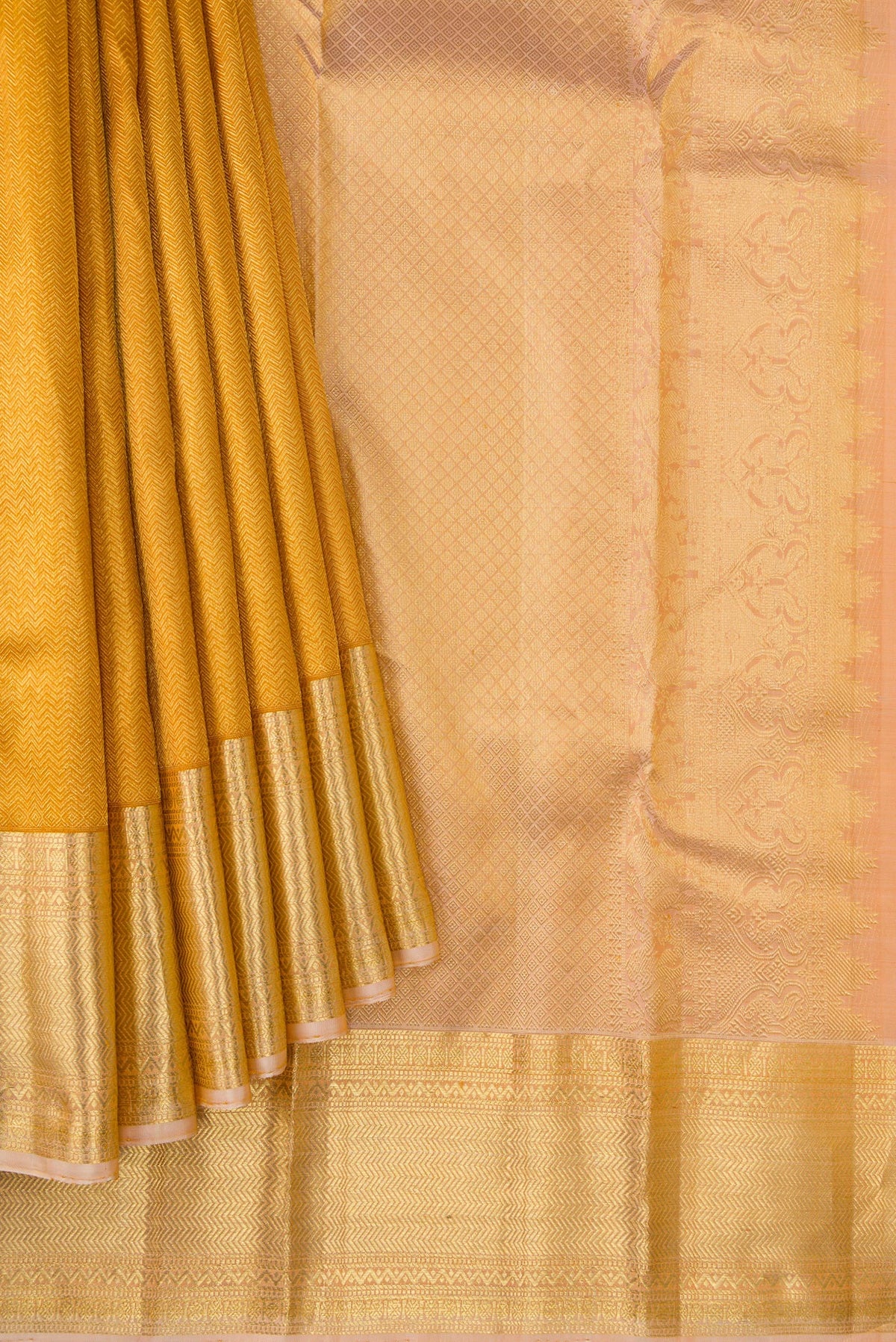 Pleats and pallu of Gold Dual Tone Kanjivaram Silk Saree with Zari Brocade on the body and Zari Border. 
