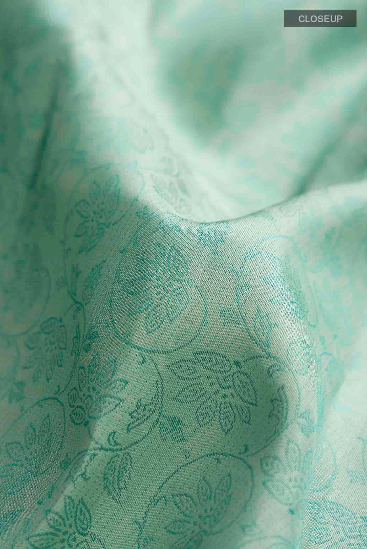 Close up of Green Kanchipuram Silk Saree with Jacquard design on the body and Zari Border displaying folds
