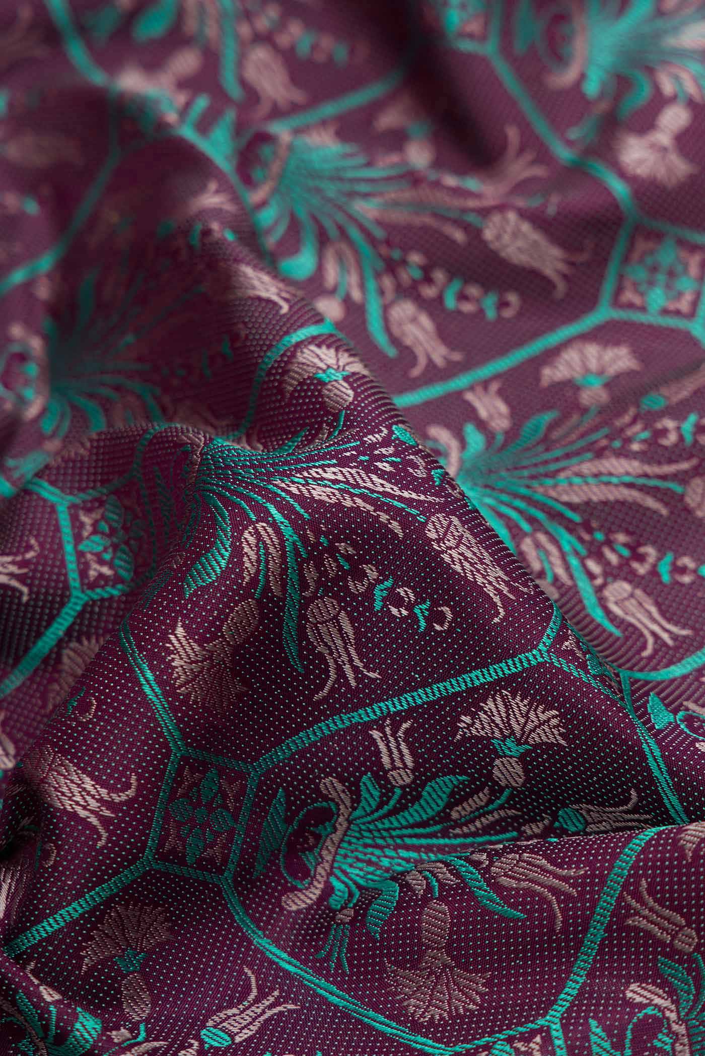 Close up of Burgundy Dual Tone Kanchipuram Silk Saree with Jacquard design on the body and Fancy Border displaying folds