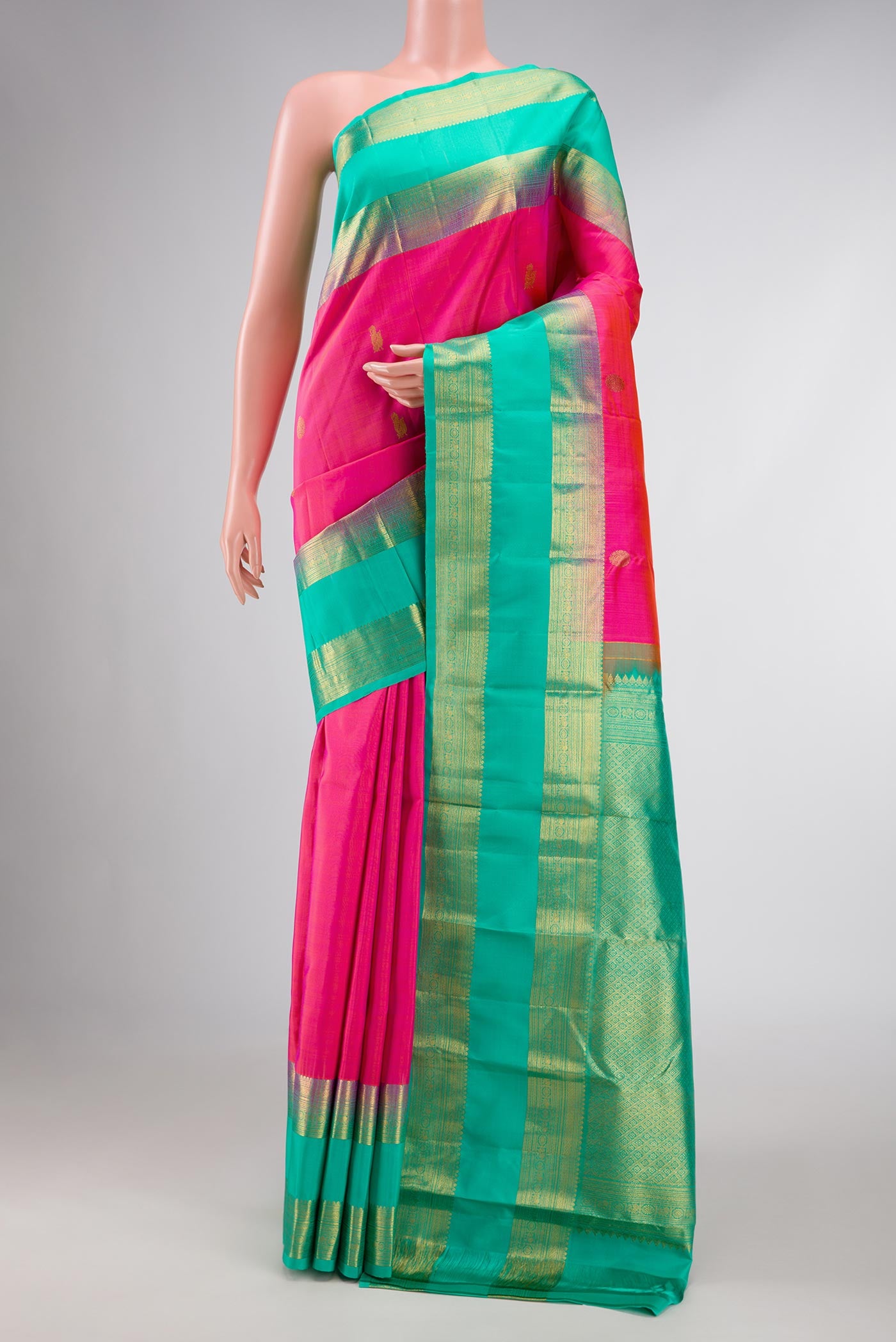 Pink Dual Tone Kanchipuram Silk Saree with Zari Butta on the body and Zari Border displayed on a mannequin