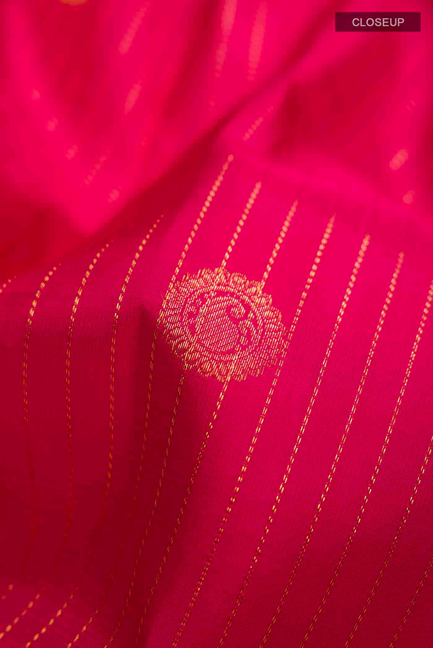 Close up of Pink Kanchipuram Silk Saree with Stripes on the body and Zari Border displaying folds
