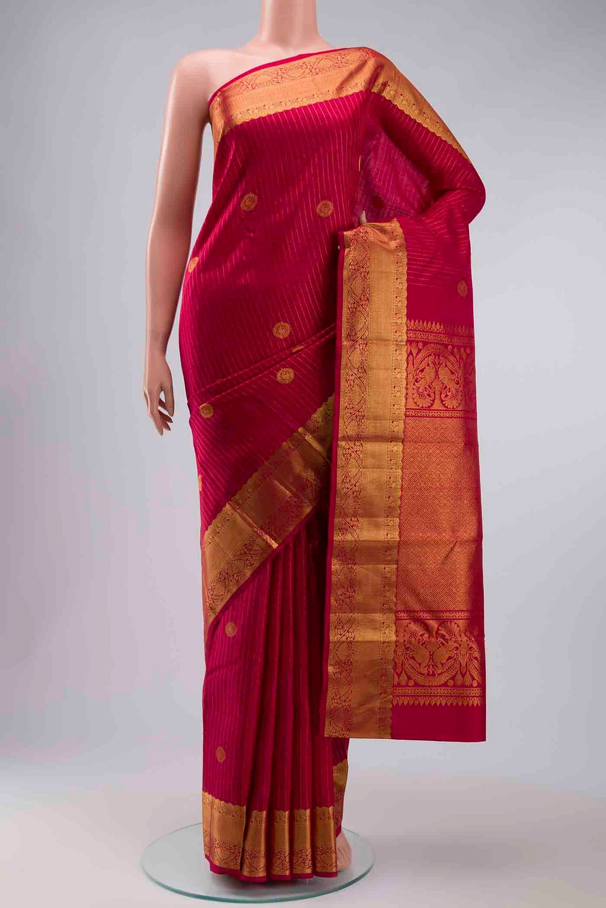 Pink Kanchipuram Silk Saree with Stripes on the body and Zari Border displayed on a mannequin