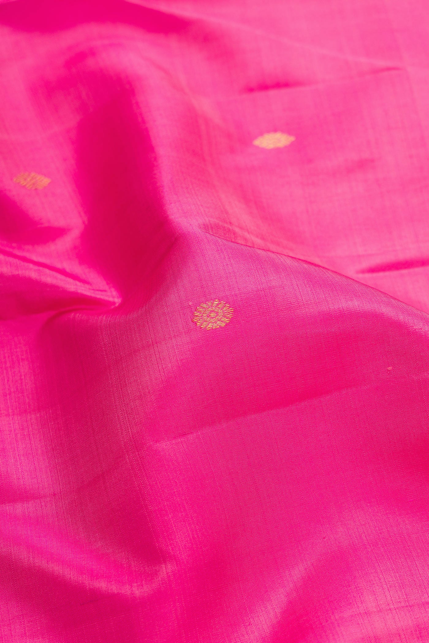 Close up of Pink Dual Tone Kanchipuram Silk Saree with Zari Butta on the body and Fancy Border.  displaying folds
