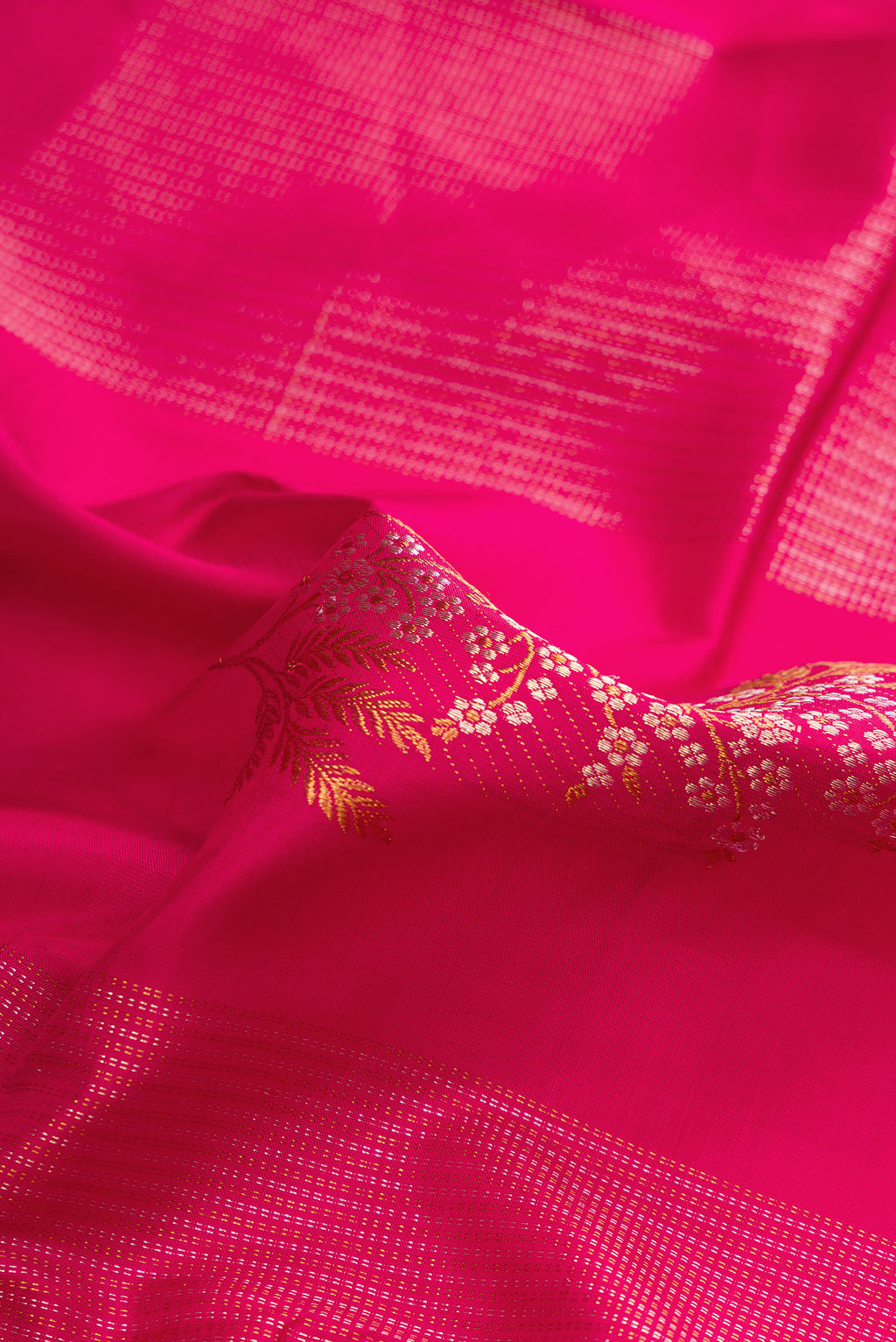 Close up of Pure Silk Dark Pink Dual Tone Kanjivaram Saree with Zari Butta on the body and Without Border.  displaying folds