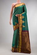 Green Dual Tone Kanjivaram Silk Saree with Checked design on the body and Zari Border.  displayed on a mannequin