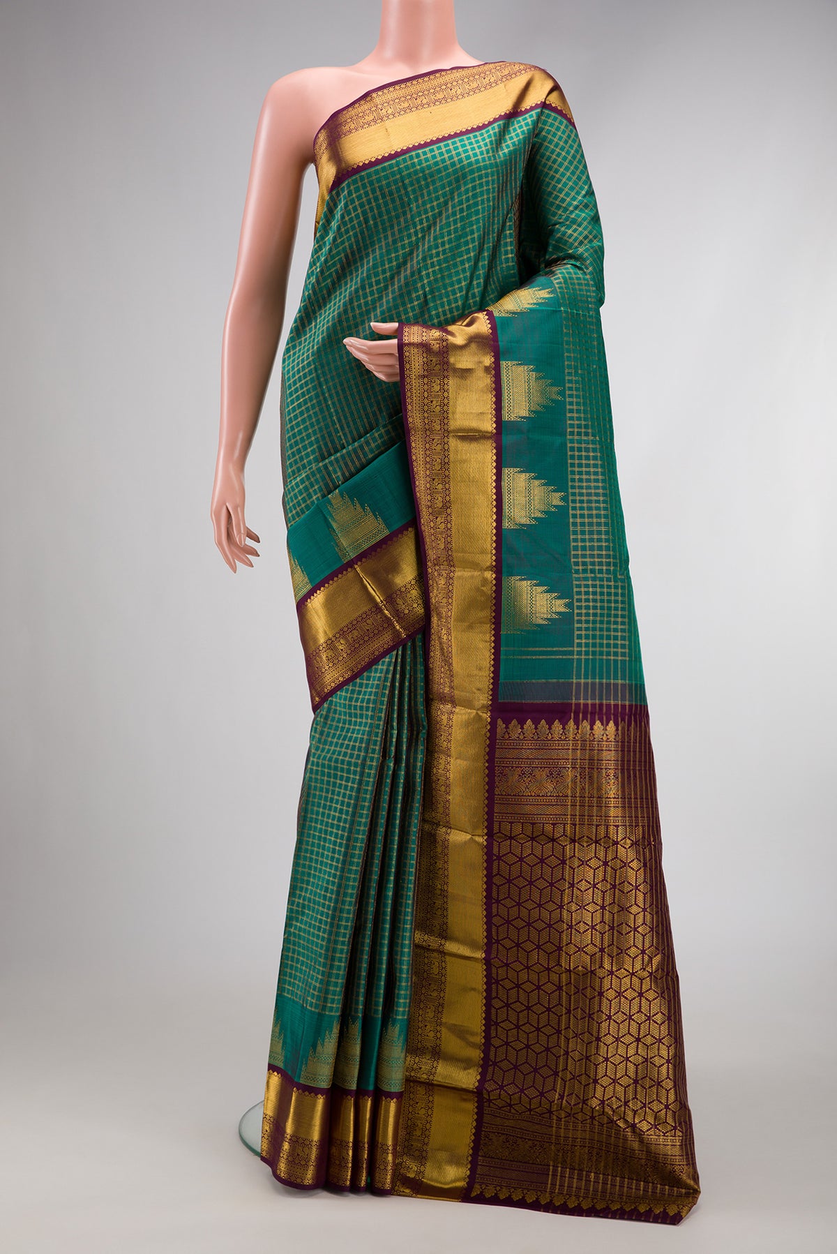 Green Dual Tone Kanjivaram Silk Saree with Checked design on the body and Zari Border.  displayed on a mannequin