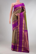Green with Purple Color Kanchipuram Silk Saree with Zari Butta on the body and Zari Border displayed on a mannequin