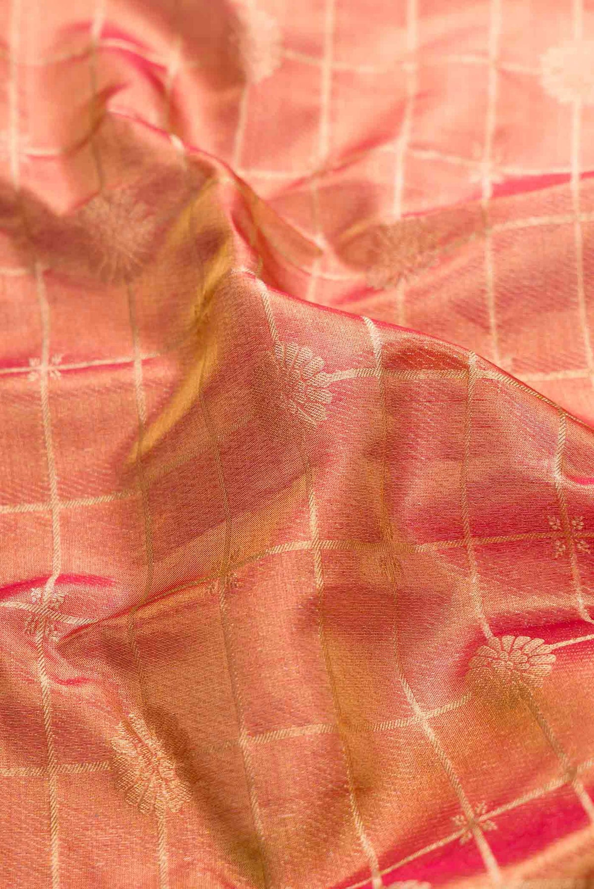Close up of Dark Pink Dual Tone Kanchipuram Tissue Silk Saree with Zari Brocade on the body and Zari Border displaying folds