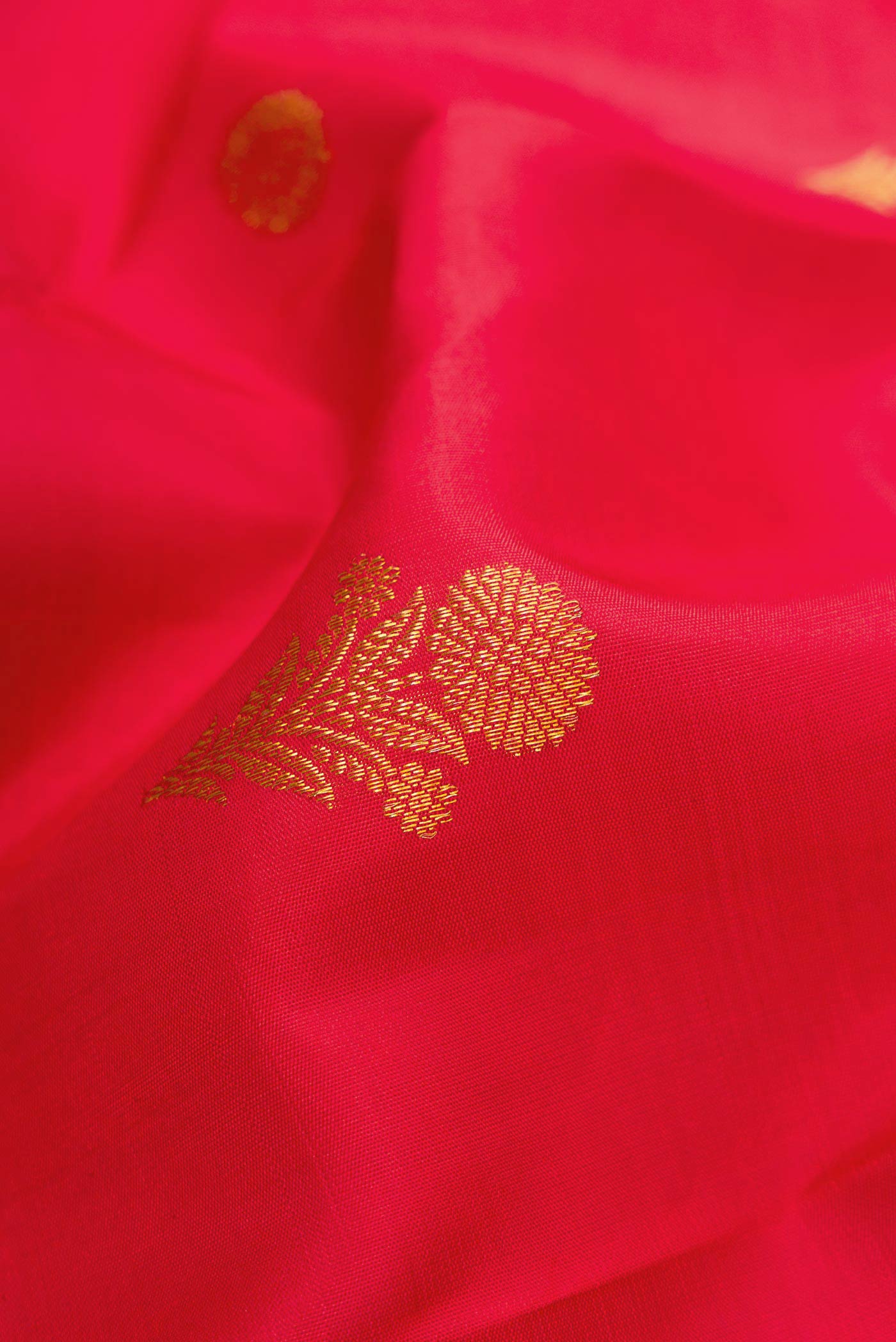 Close up of Red Dual Tone Kanjivaram Silk Saree with Zari Butta on the body and Fancy Border.  displaying folds