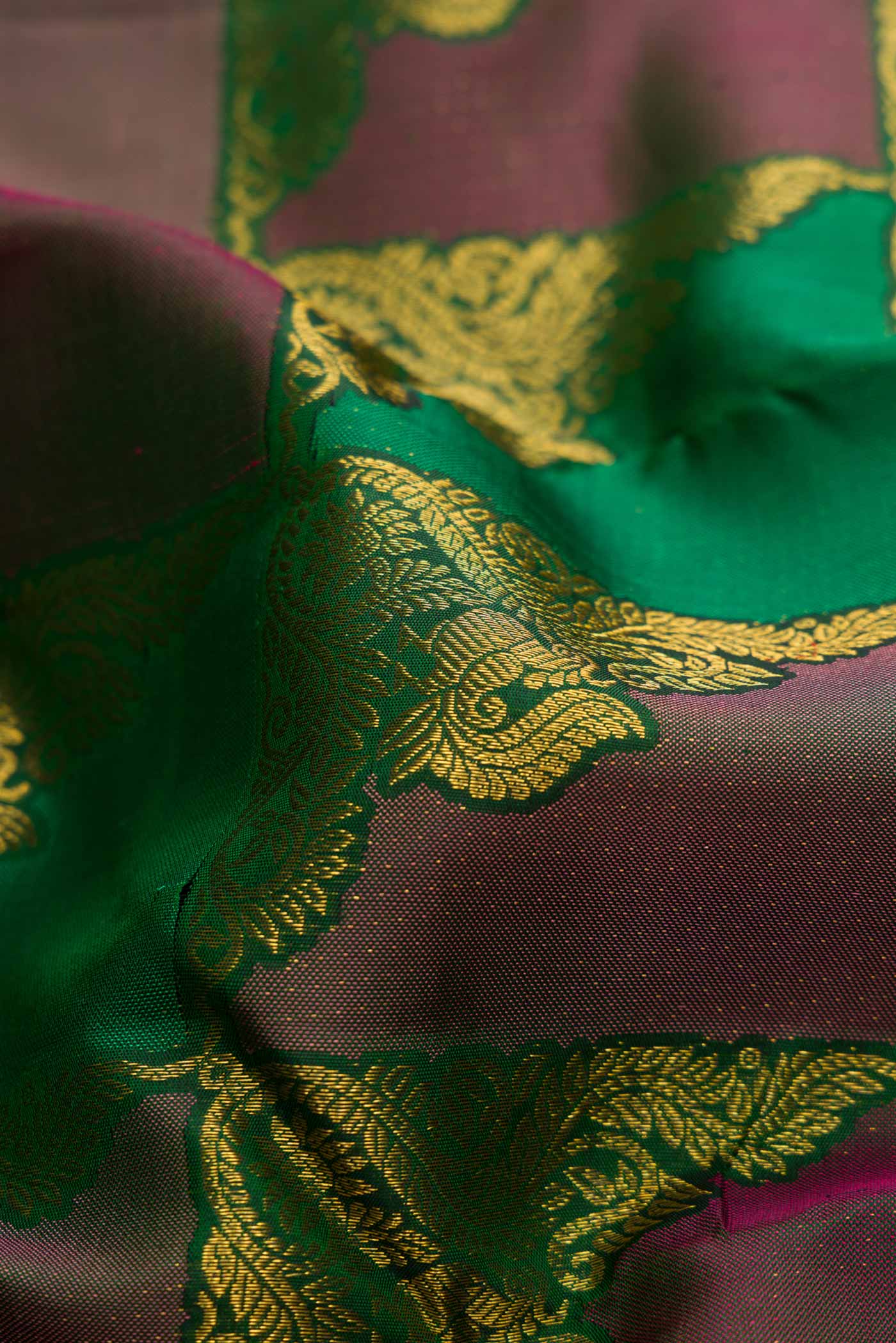 Close up of Bottle Green Dual Tone Kanchipuram Silk Saree with Zari Brocade on the body and Without Border displaying folds