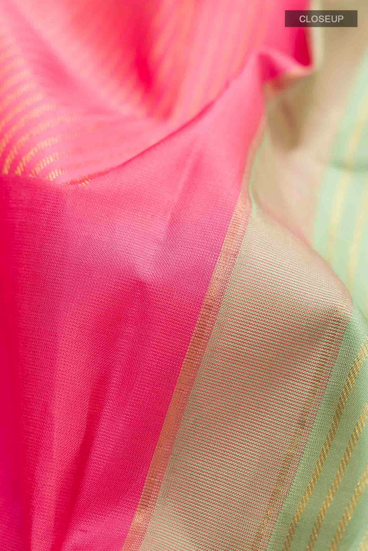 Close up of Green Kanchipuram Silk Saree with Stripes on the body and Without Border displaying folds