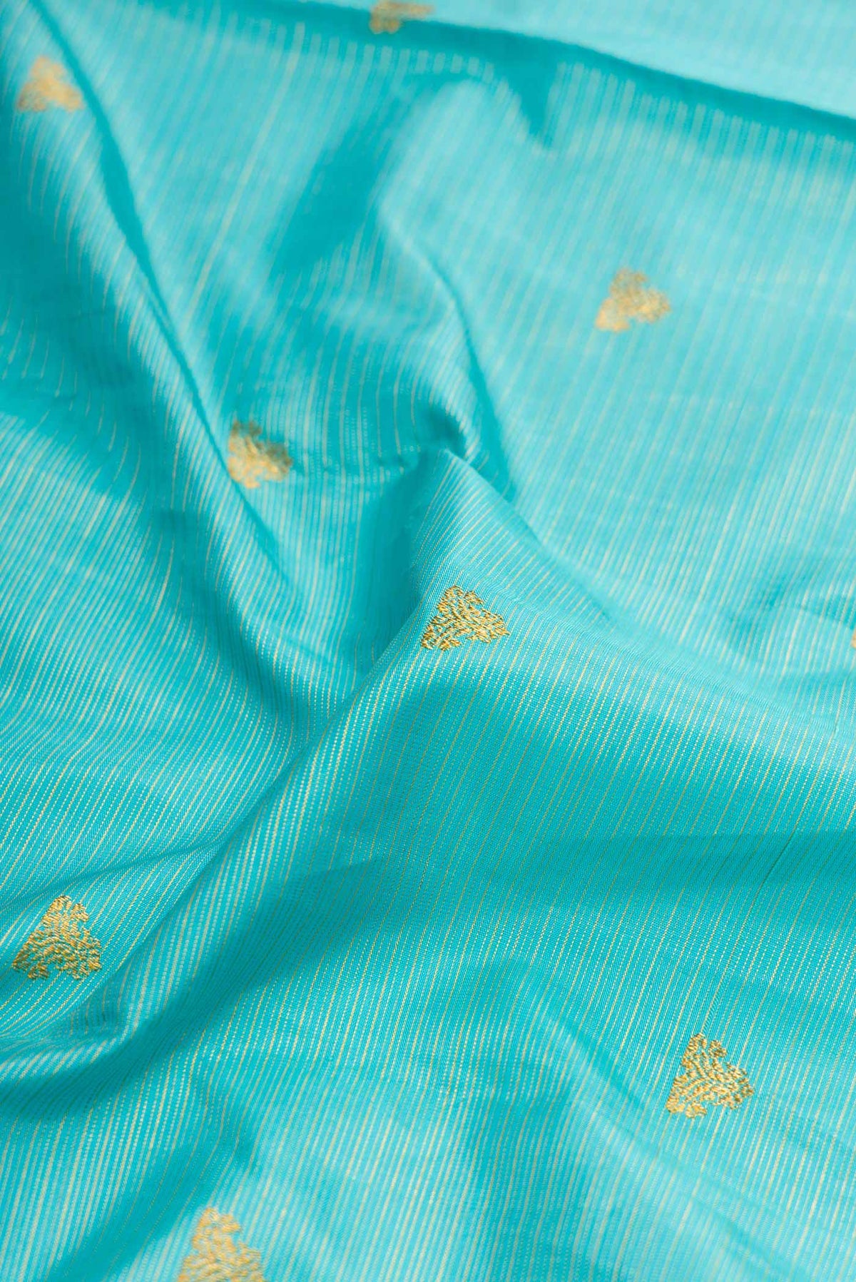 Close up of Sky Blue Dual Tone Kanchipuram Silk Saree with Stripes on the body and Zari Border displaying folds