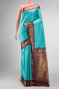 Sky Blue Dual Tone Kanchipuram Silk Saree with Stripes on the body and Zari Border displayed on a mannequin
