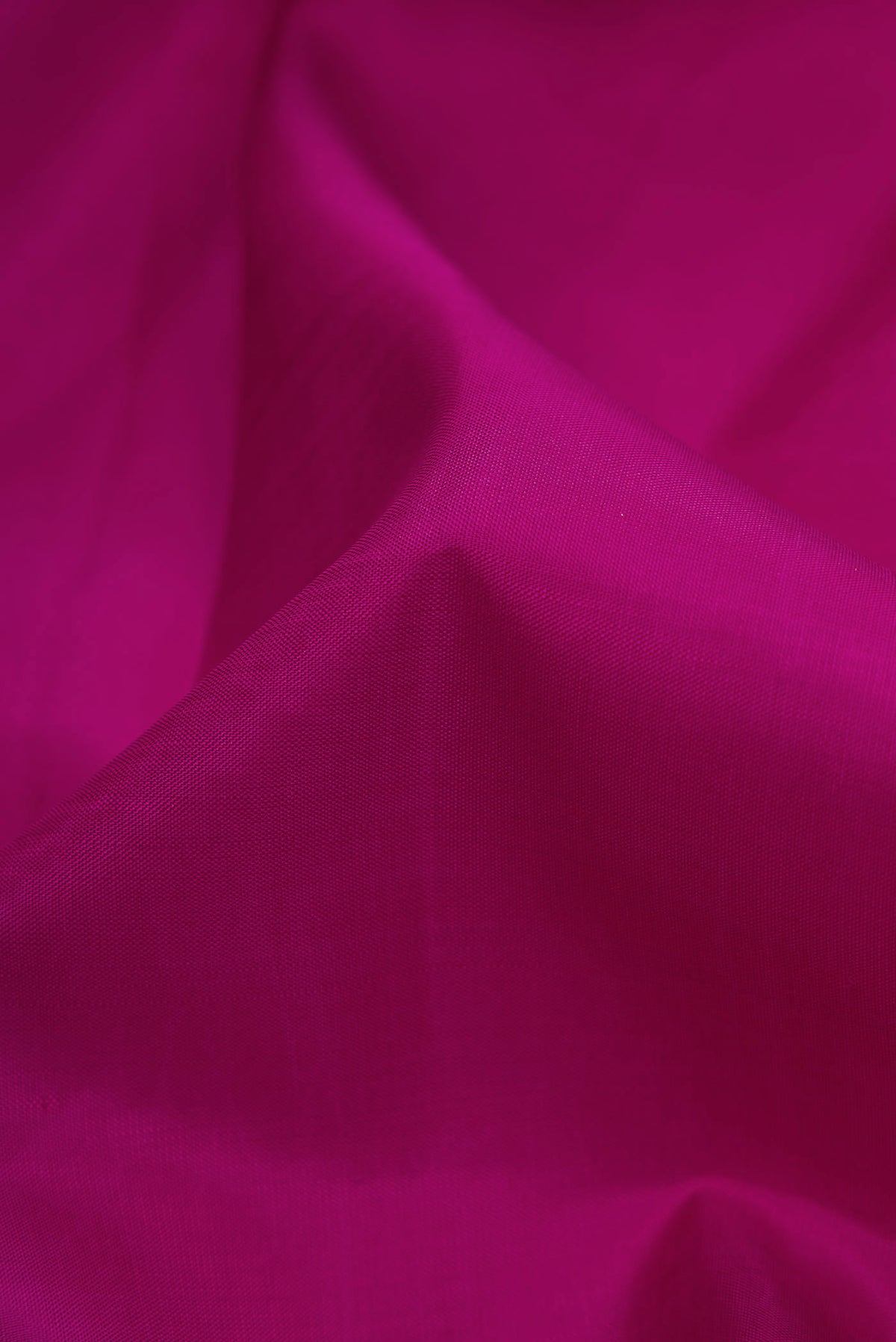 Close up of Magenta Dual Tone Kanchipuram Silk Saree with Plain Body and Fancy Border displaying folds