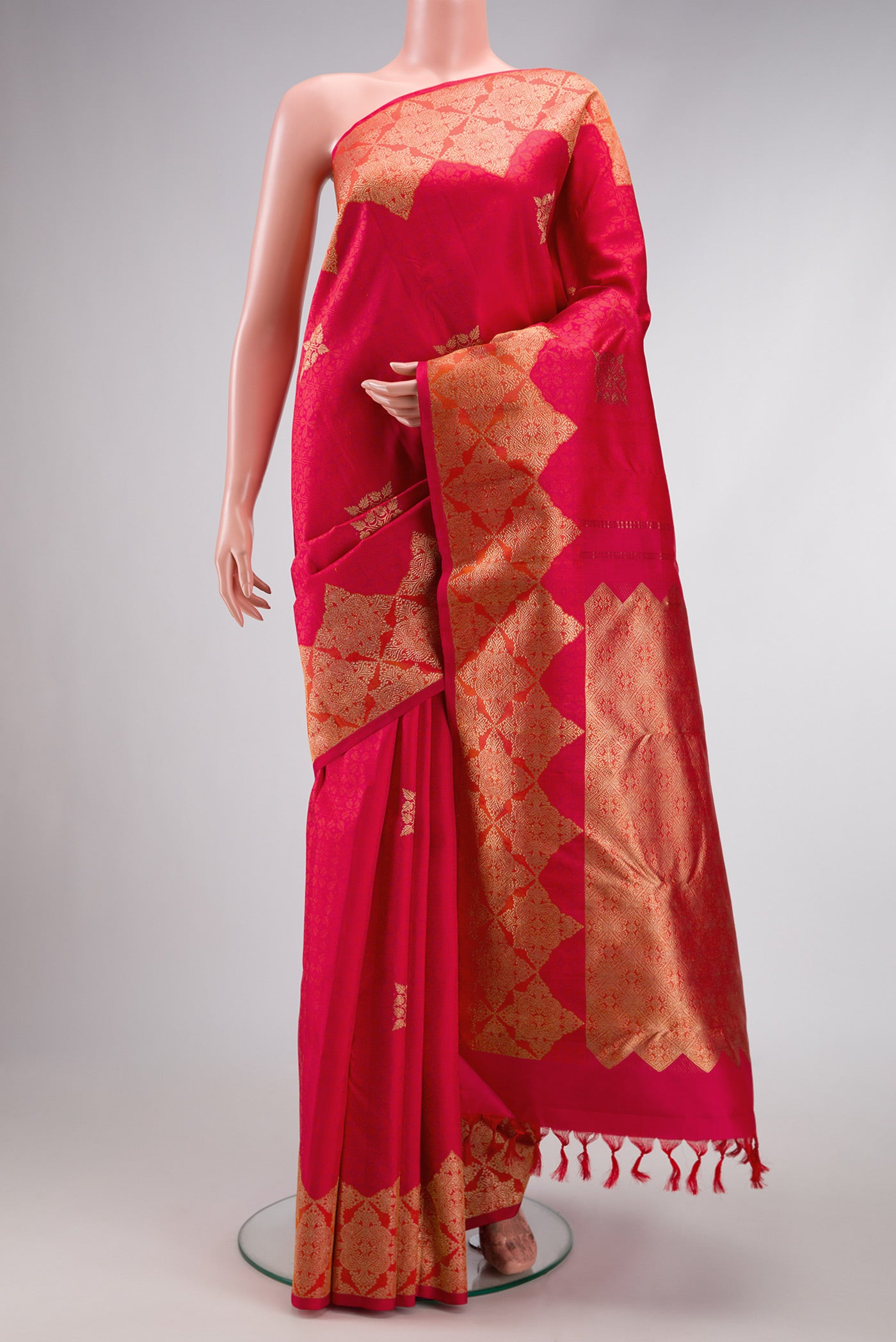 Red Dual Tone Kanjivaram Silk Saree with Zari Butta on the body and Fancy Border.  displayed on a mannequin