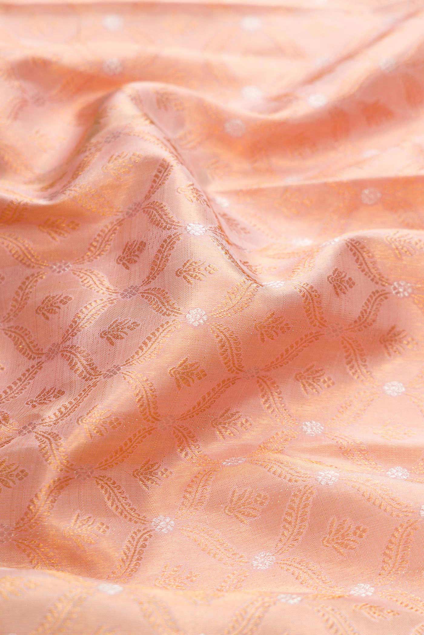 Close up of Rose Gold Dual Tone Kanchipuram Silk Saree with Zari Brocade on the body and Zari Border displaying folds
