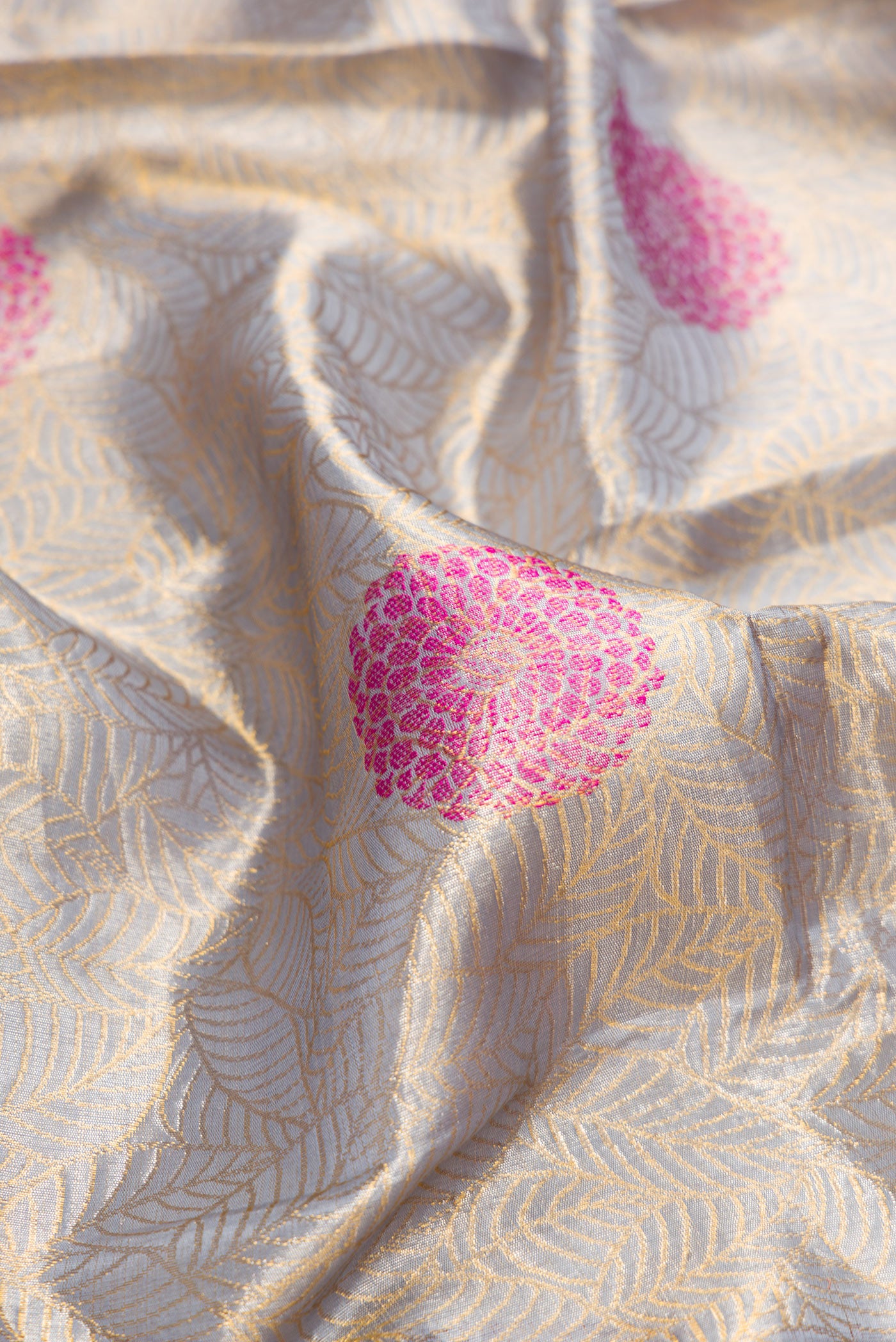 Close up of Grey Dual Tone Kanchipuram Tissue Silk Saree with Zari Brocade on the body and Fancy Border.  displaying folds