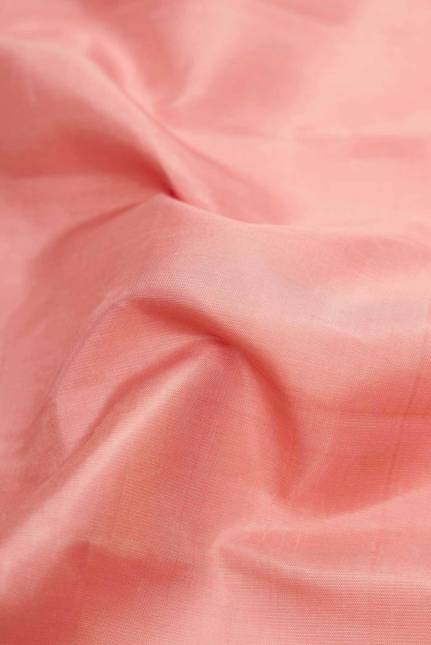 Close up of Rose Gold Dual Tone Kanchipuram Silk Saree with Plain Body and Fancy Border displaying folds