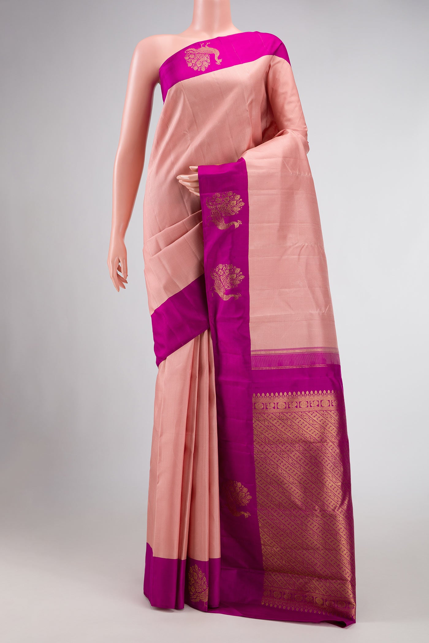 Rose Gold Dual Tone Kanchipuram Silk Saree with Plain Body and Fancy Border displayed on a mannequin