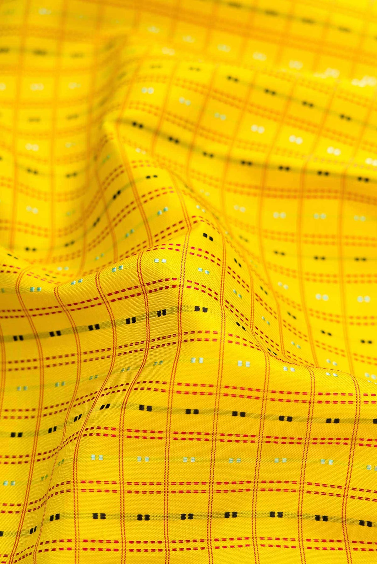 Close up of Yellow Dual Tone Kanchipuram Silk Saree with Checked design on the body and Zari Border.  displaying folds