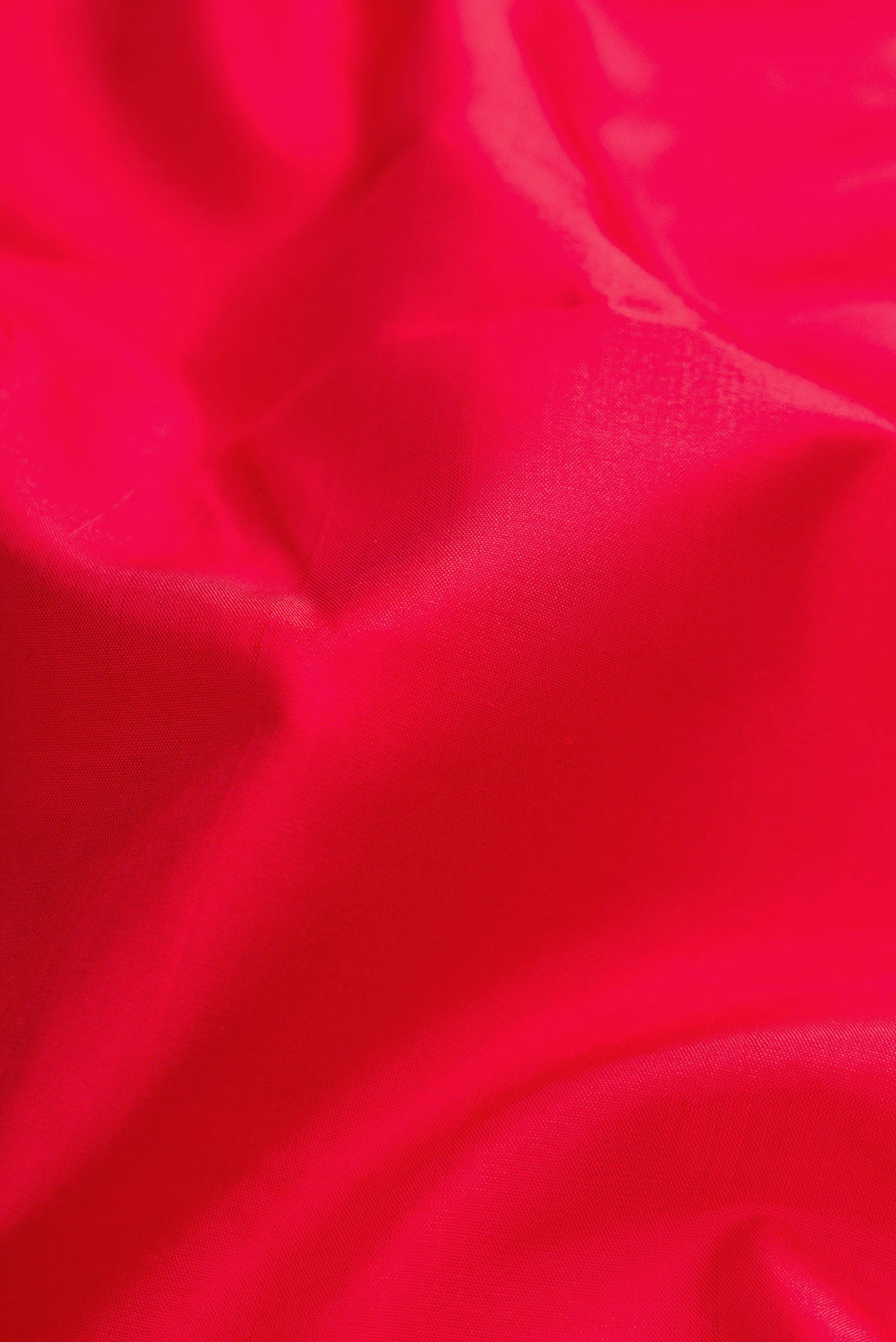 Close up of Red Dual Tone Kanchipuram Silk Saree with Plain Body and Thread Border displaying folds