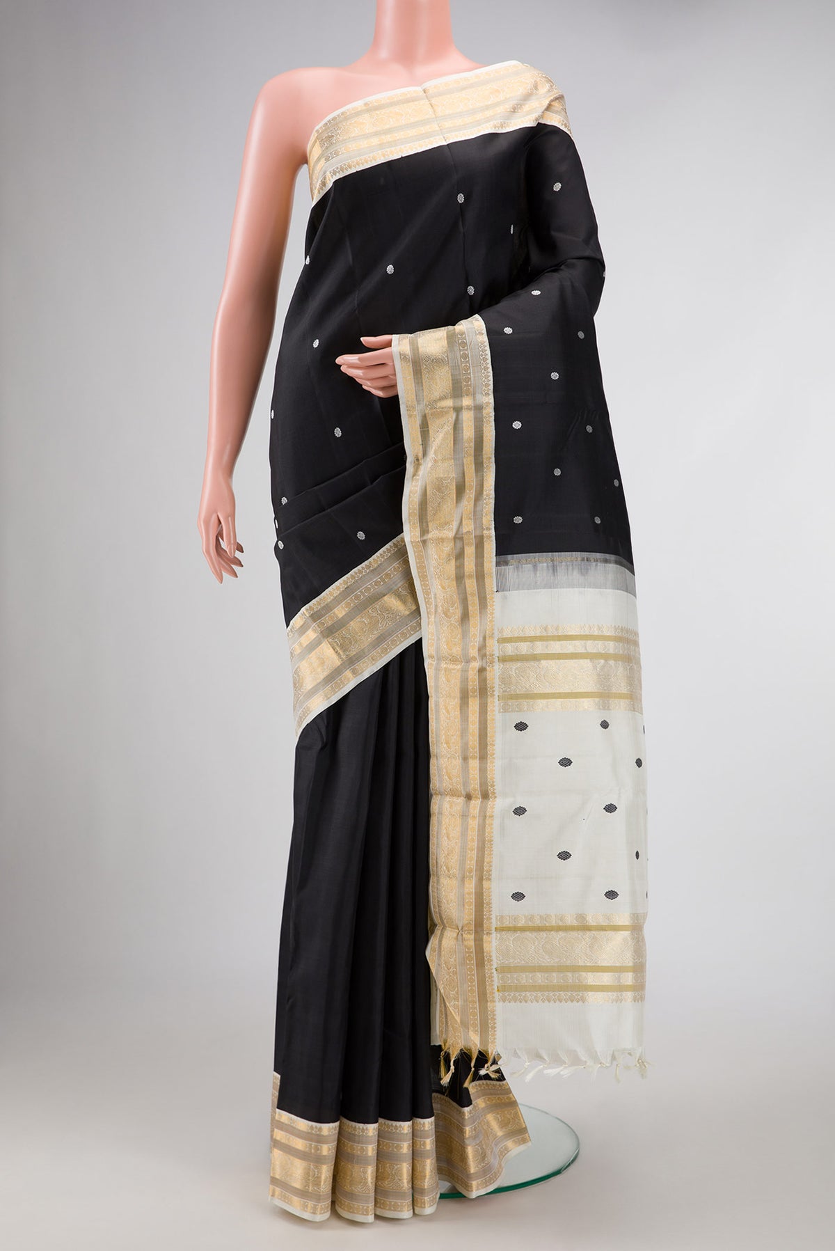 Black Dual Tone Kanchipuram Silk Saree with Thread Butta on the body and Zari Border displayed on a mannequin