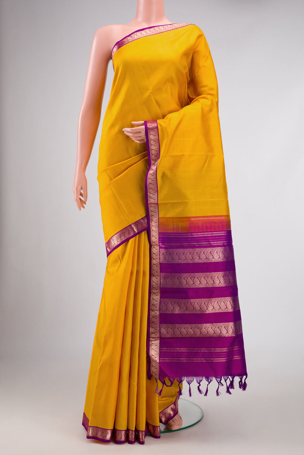 Mustard Dual Tone Kanjivaram Silk Saree with Plain Body and Zari Border.  displayed on a mannequin