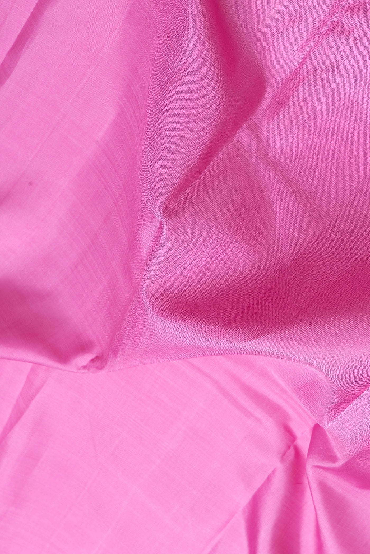 Close up of Pink Dual Tone Kanjivaram Silk Saree with Plain Body and Zari Border.  displaying folds