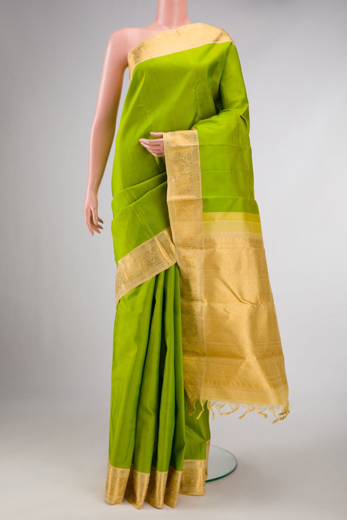 Parrot Green Dual Tone Kanchipuram Silk Saree with Plain Body and Zari Border displayed on a mannequin