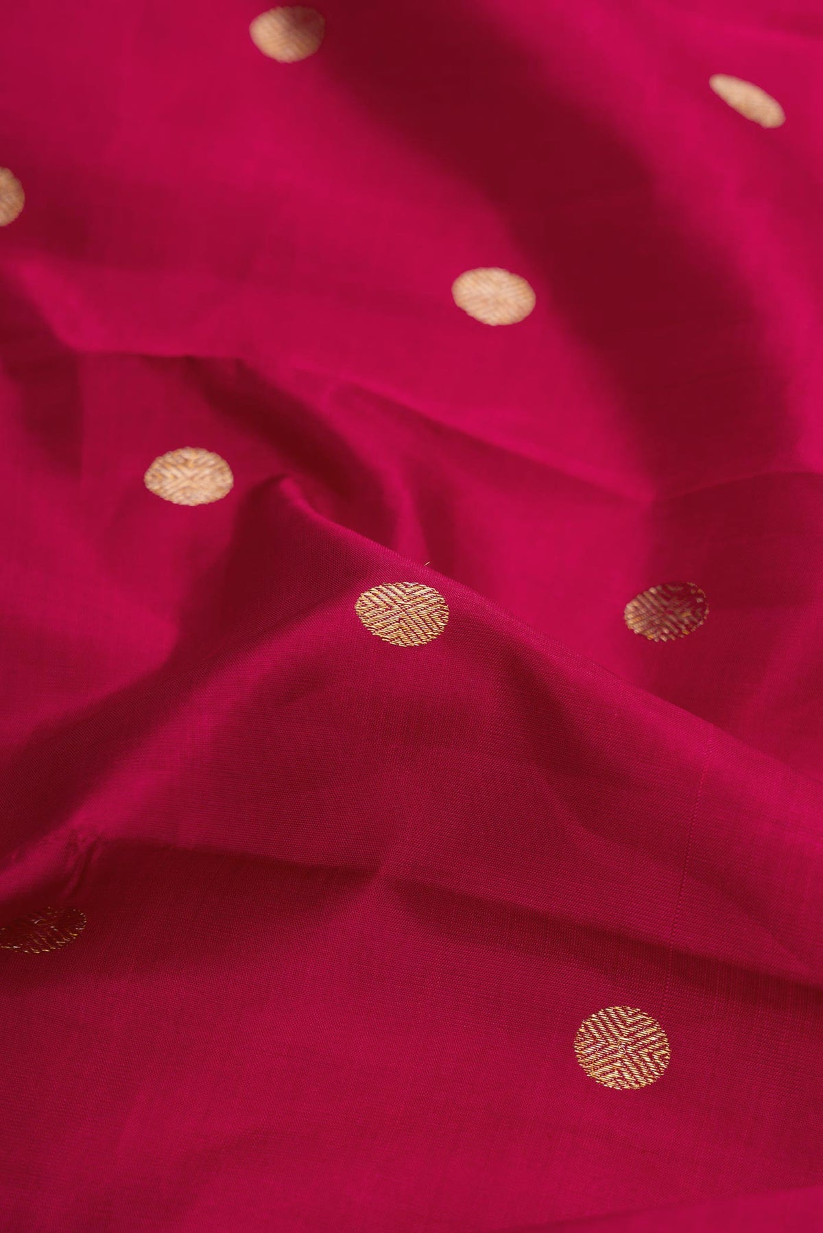 Close up of Maroon Dual Tone Kanchipuram Silk Saree with Zari Butta on the body and Zari Border displaying folds