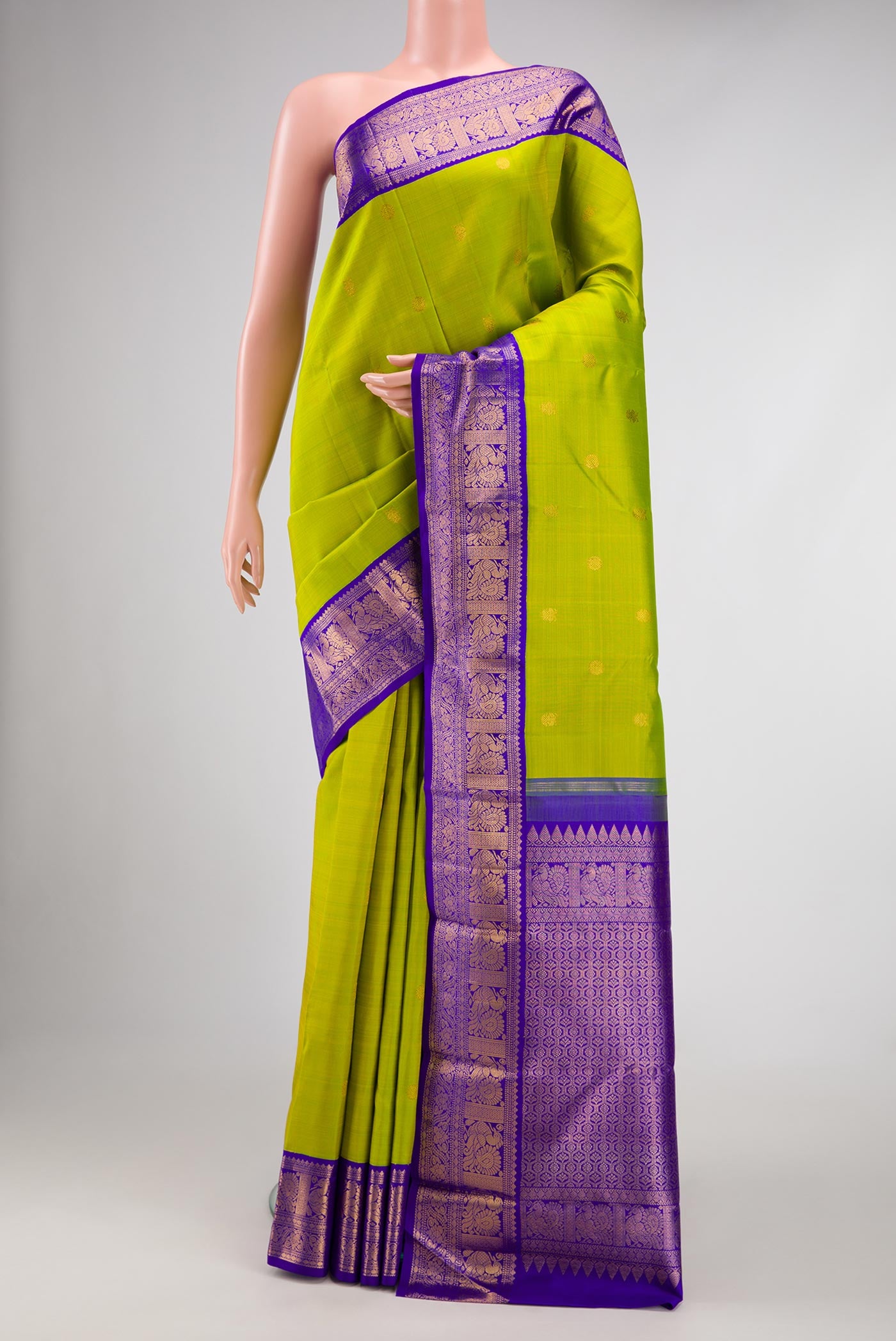 Parrot Green Dual Tone Kanjivaram Silk Saree with Zari Butta on the body and Zari Border.  displayed on a mannequin