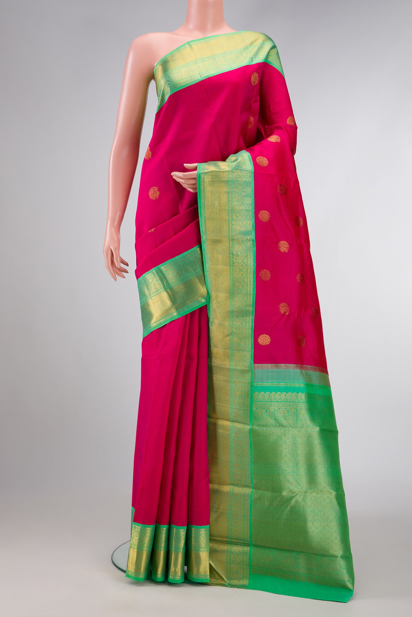 Pink Dual Tone Kanjivaram Silk Saree with Zari Butta on the body and Zari Border.  displayed on a mannequin