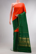 Orange Dual Tone Kanjivaram Silk Saree with Zari Butta on the body and Zari Border.  displayed on a mannequin