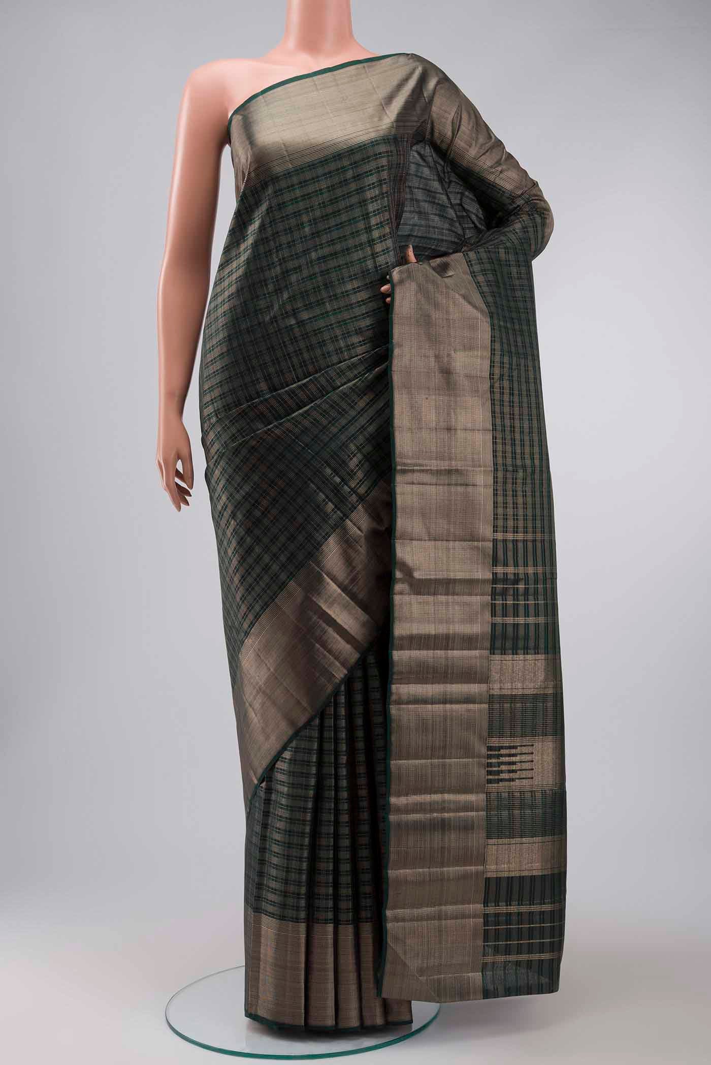 Green Kanchipuram Silk Saree with Checked design on the body and Zari Border displayed on a mannequin