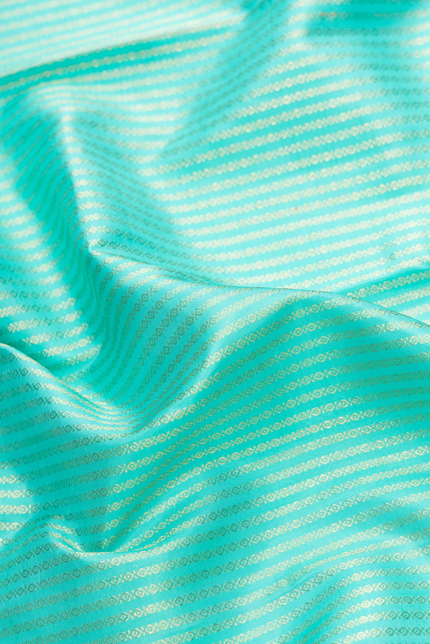 Close up of Sea Green Dual Tone Kanchipuram Silk Saree with Zari Brocade on the body and Zari Border.  displaying folds
