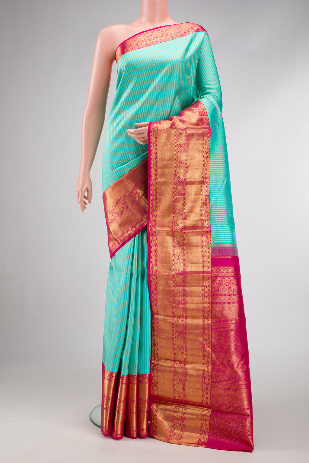 Sea Green Dual Tone Kanchipuram Silk Saree with Zari Brocade on the body and Zari Border.  displayed on a mannequin