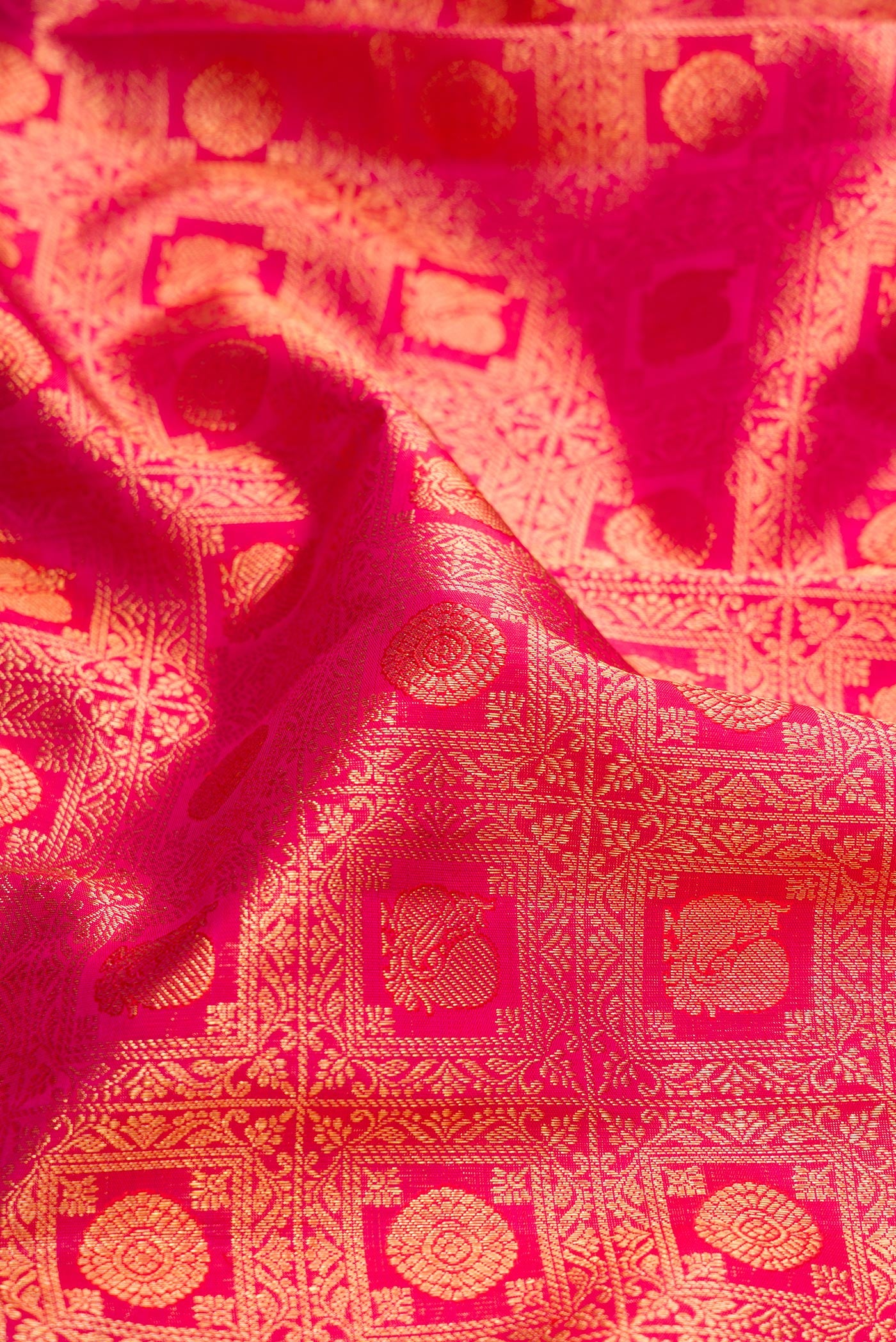 Close up of Pink Dual Tone Kanchipuram Silk Saree with Zari Brocade on the body and Zari Border.  displaying folds