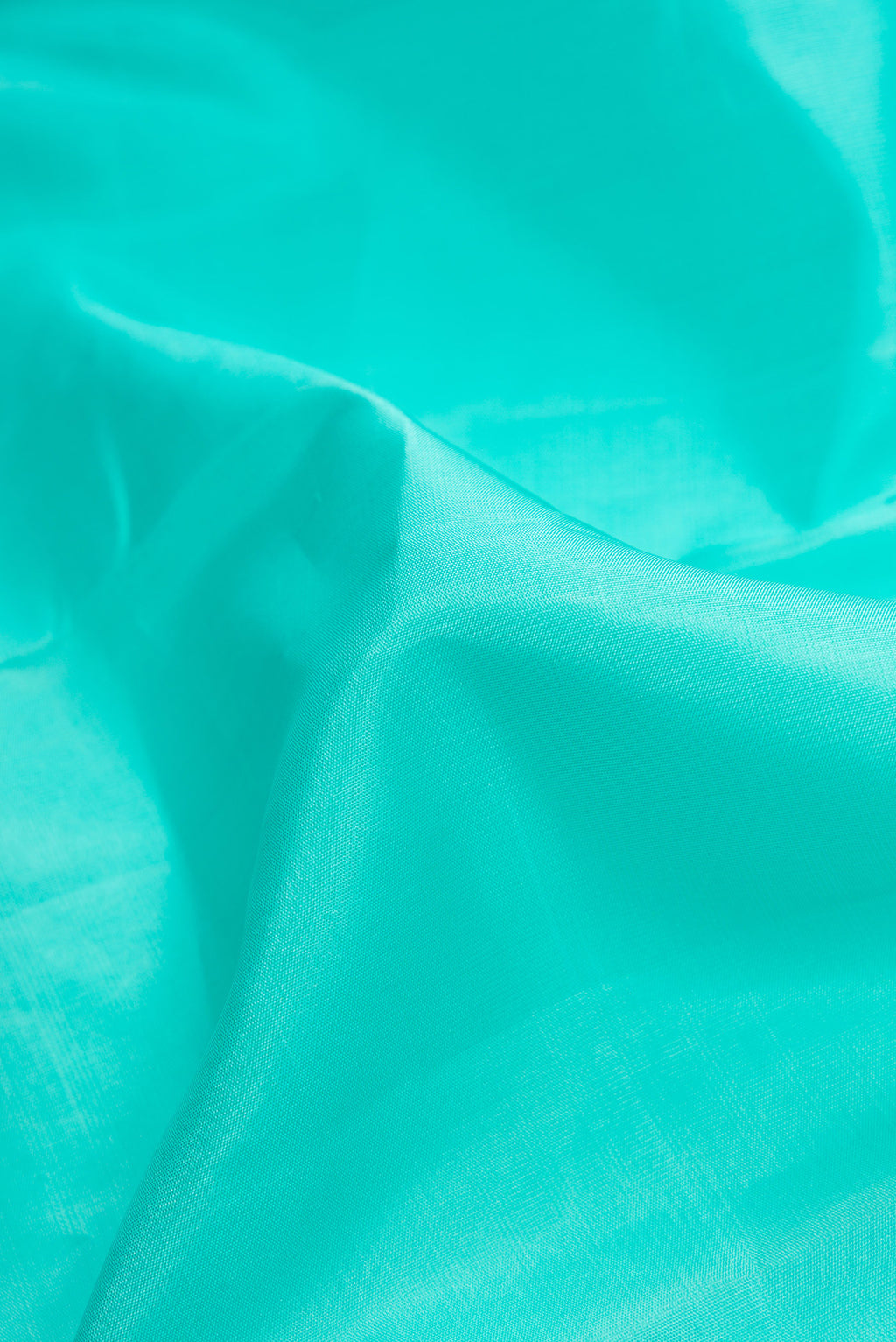 Close up of Sea Green Dual Tone Kanjivaram Silk Saree with Plain Body and Zari Border.  displaying folds