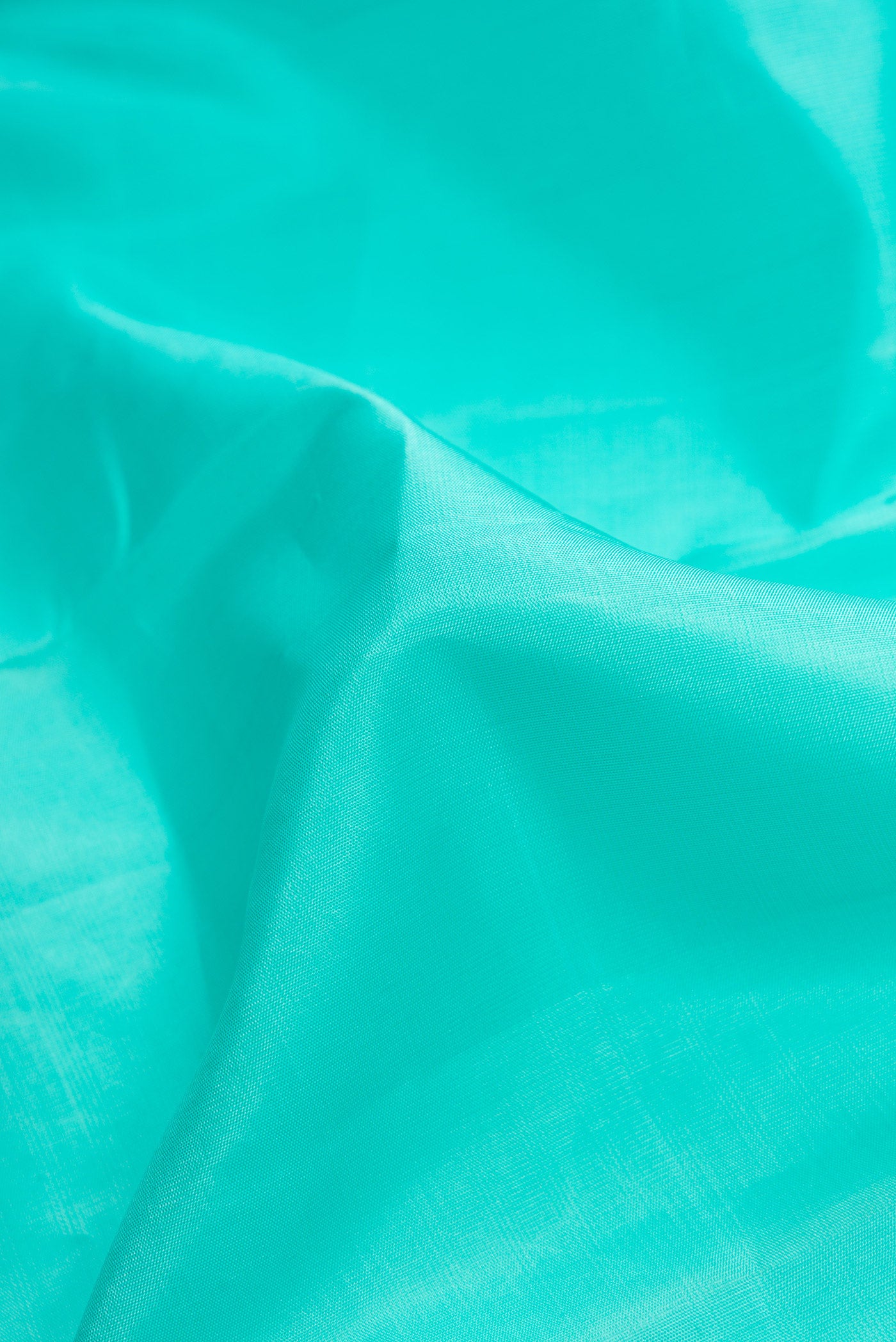 Close up of Sea Green Dual Tone Kanjivaram Silk Saree with Plain Body and Zari Border.  displaying folds