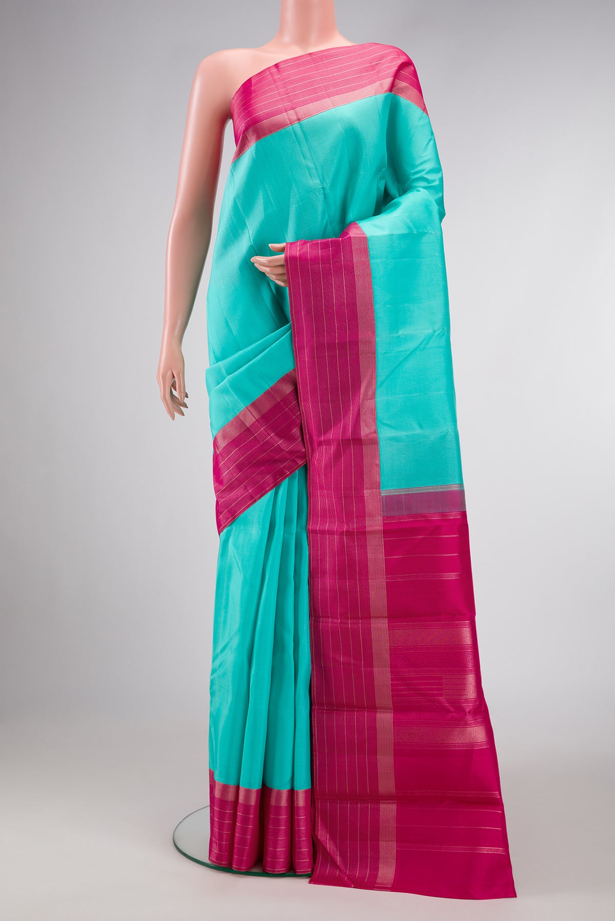 Sea Green Dual Tone Kanjivaram Silk Saree with Plain Body and Zari Border.  displayed on a mannequin