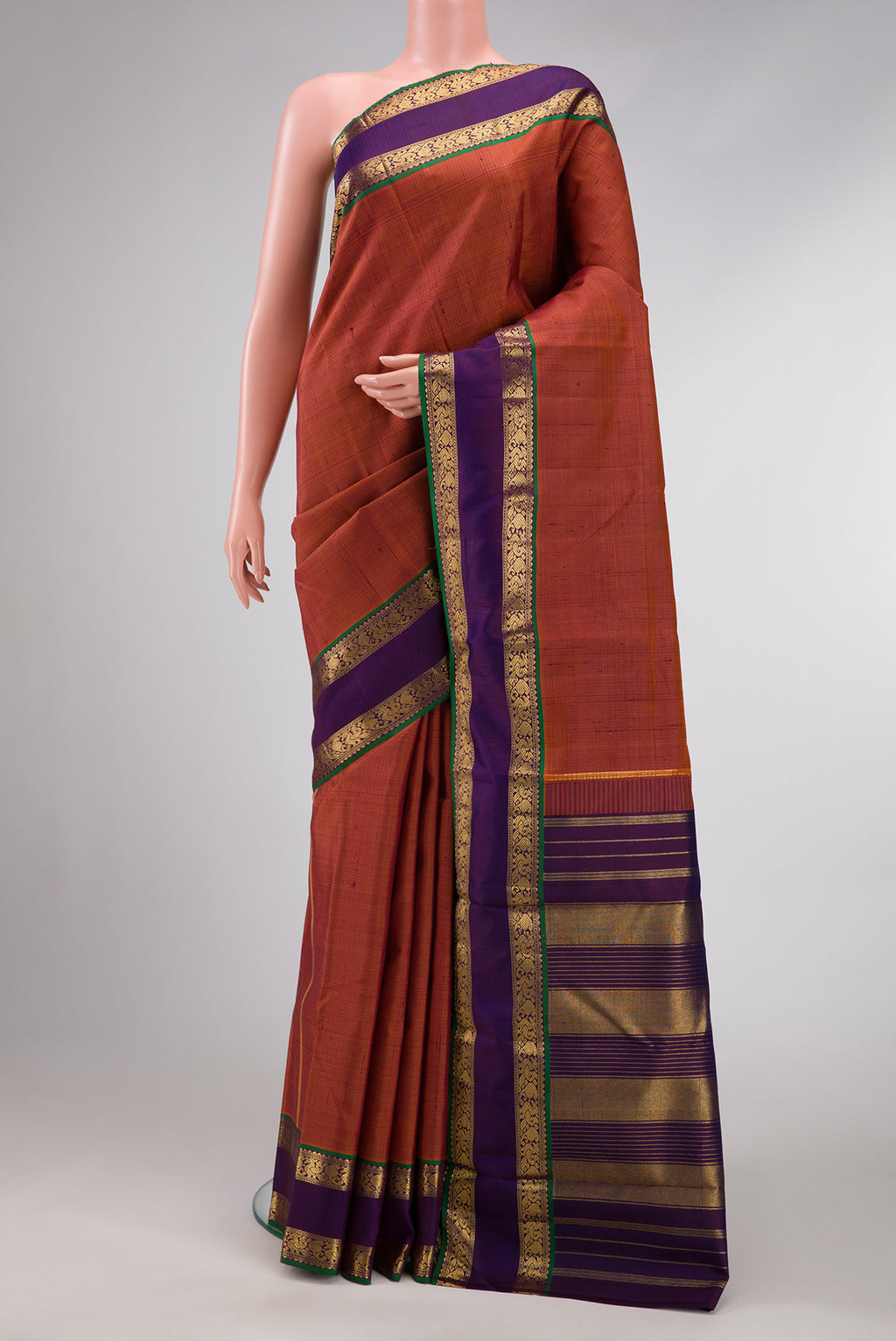 Brick Orange Dual Tone Kanjivaram Silk Saree with Stripes on the body and Zari Border.  displayed on a mannequin