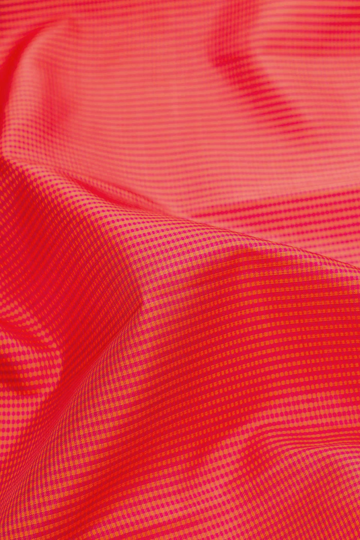 Close up of Dark Pink Dual Tone Kanjivaram Silk Saree with Checked design on the body and Zari Border.  displaying folds
