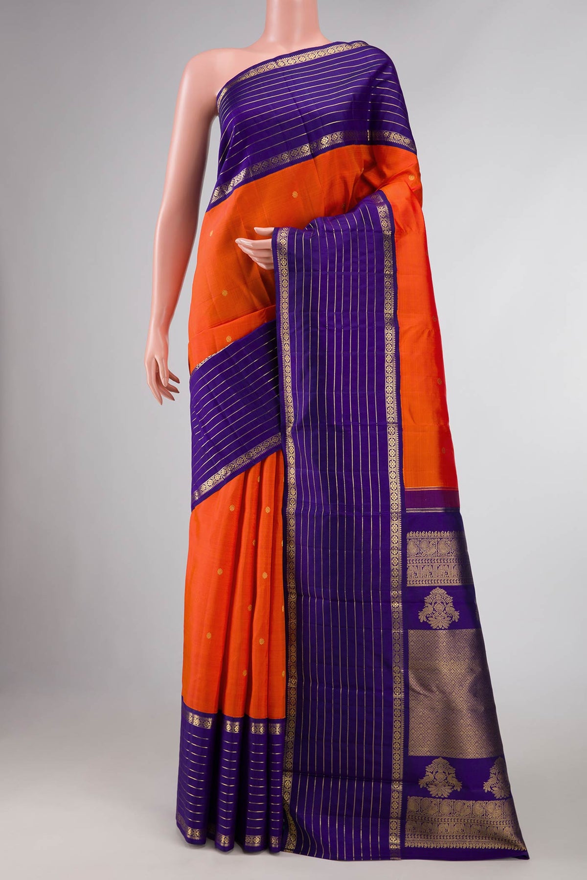 Orange Dual Tone Kanchipuram Silk Saree with Zari Butta on the body and Zari Border displayed on a mannequin