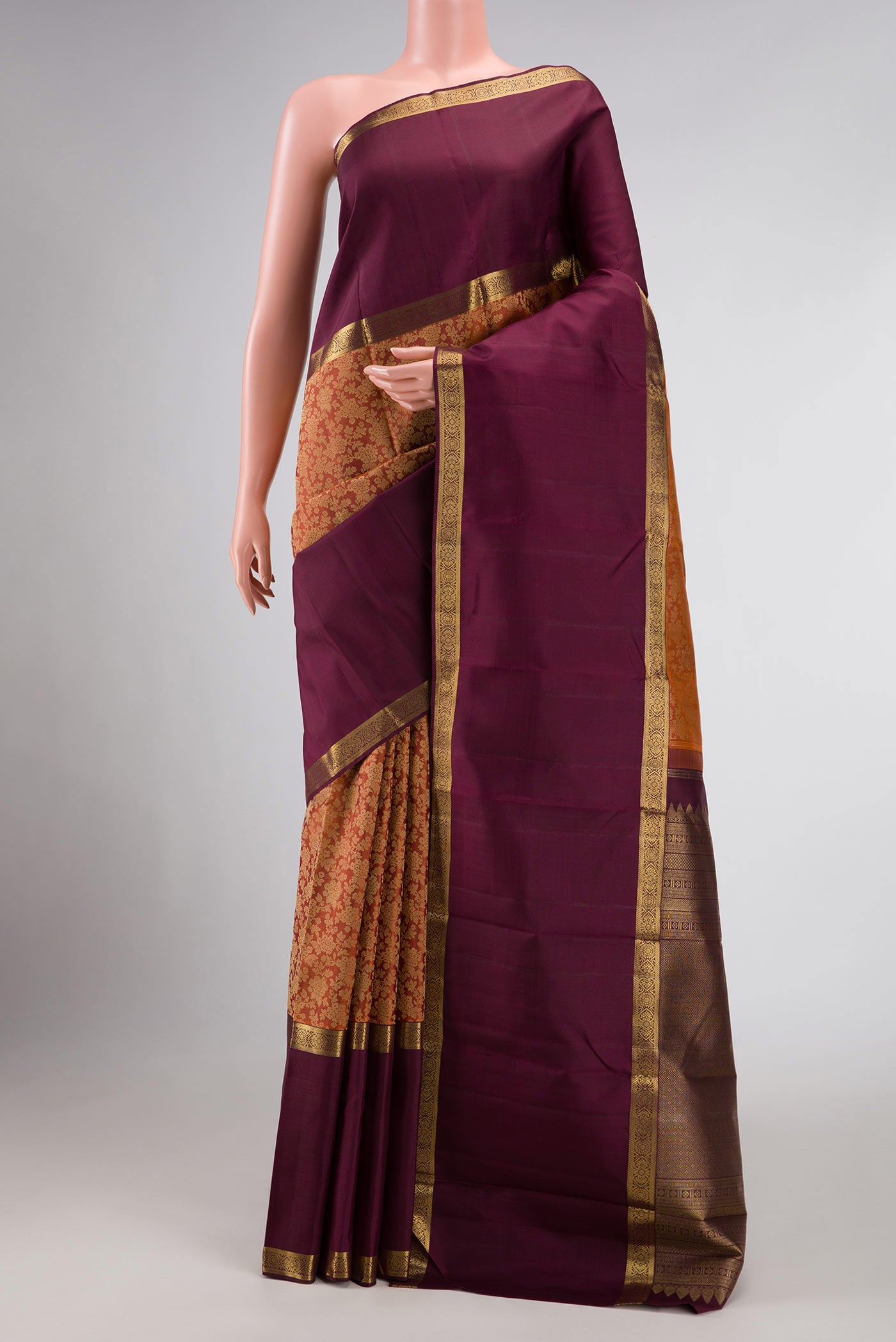 Brick Orange Dual Tone Kanchipuram Silk Saree with Jacquard design on the body and Zari Border displayed on a mannequin